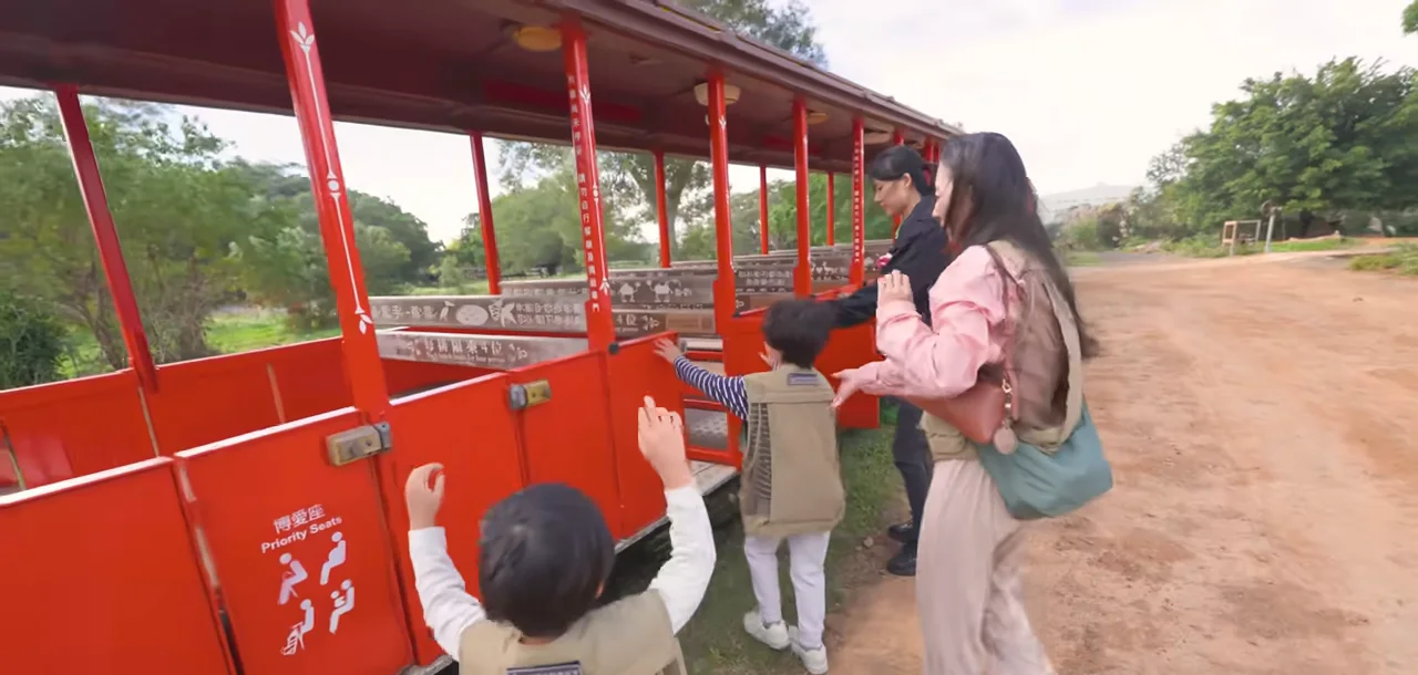 Queenie 牽著孩子準備登上六福村紅色遊園列車