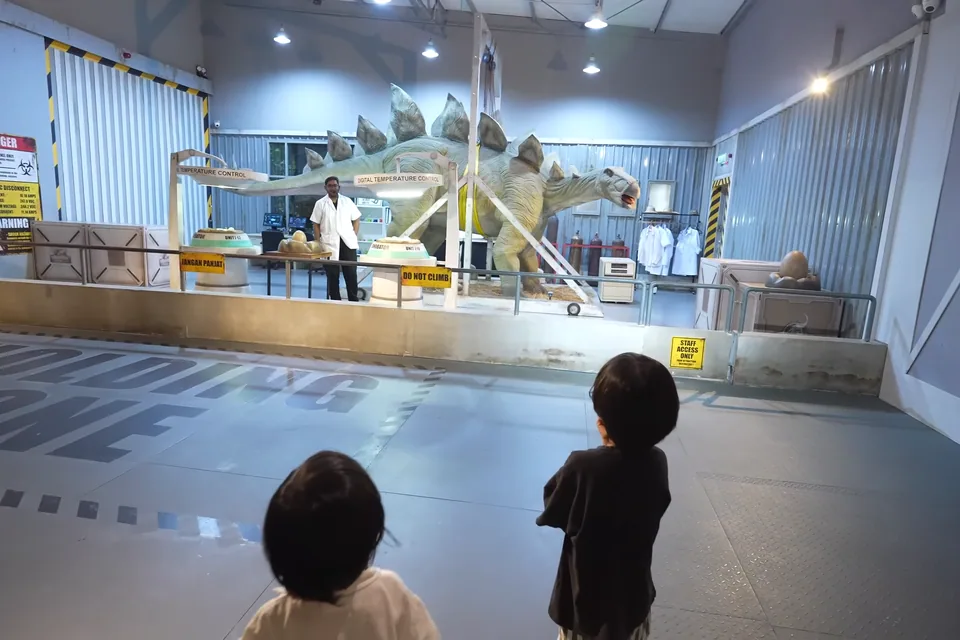 孩子在侏羅紀主題展示區觀看恐龍骨架